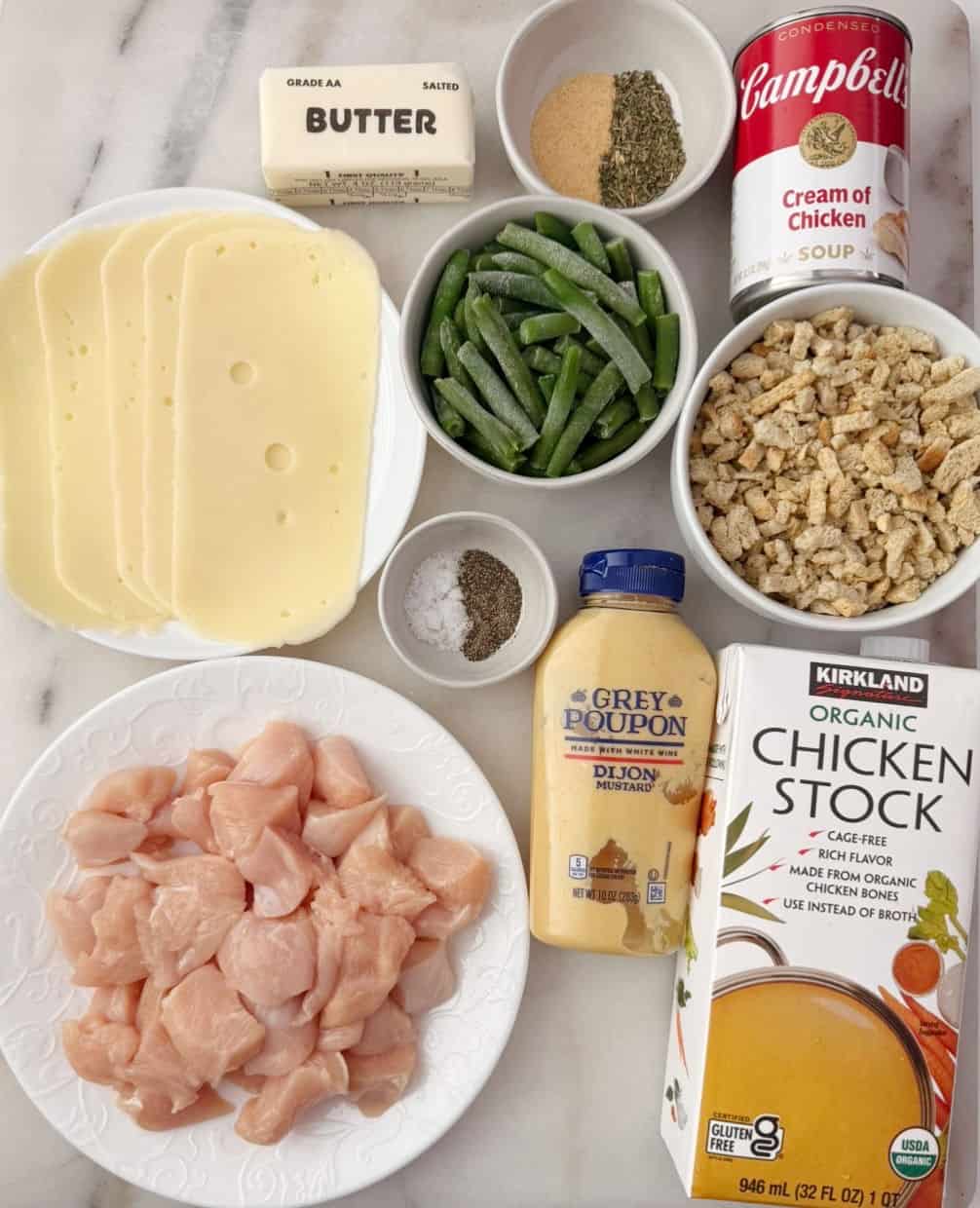 cubed chicken, Swiss cheese, stuffing mix, green beans, cream of chicken,, mustard, broth, spices, butter.