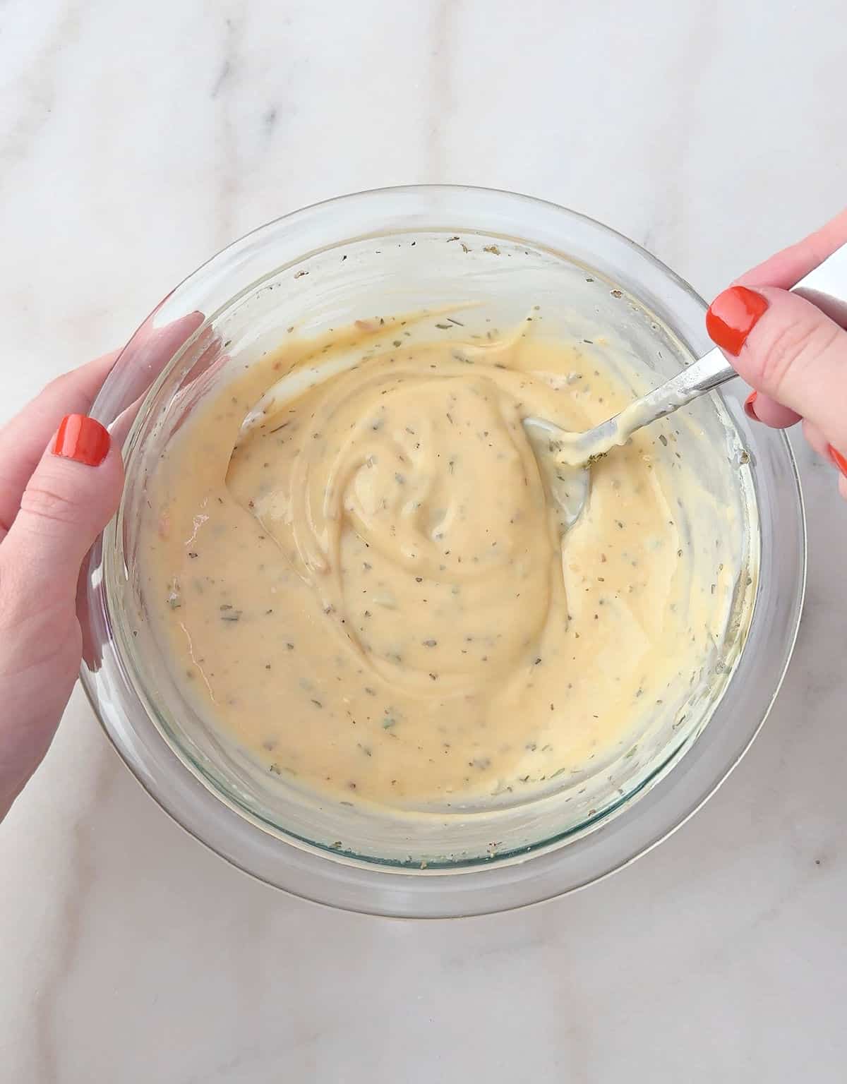 mixing sauce in bowl.