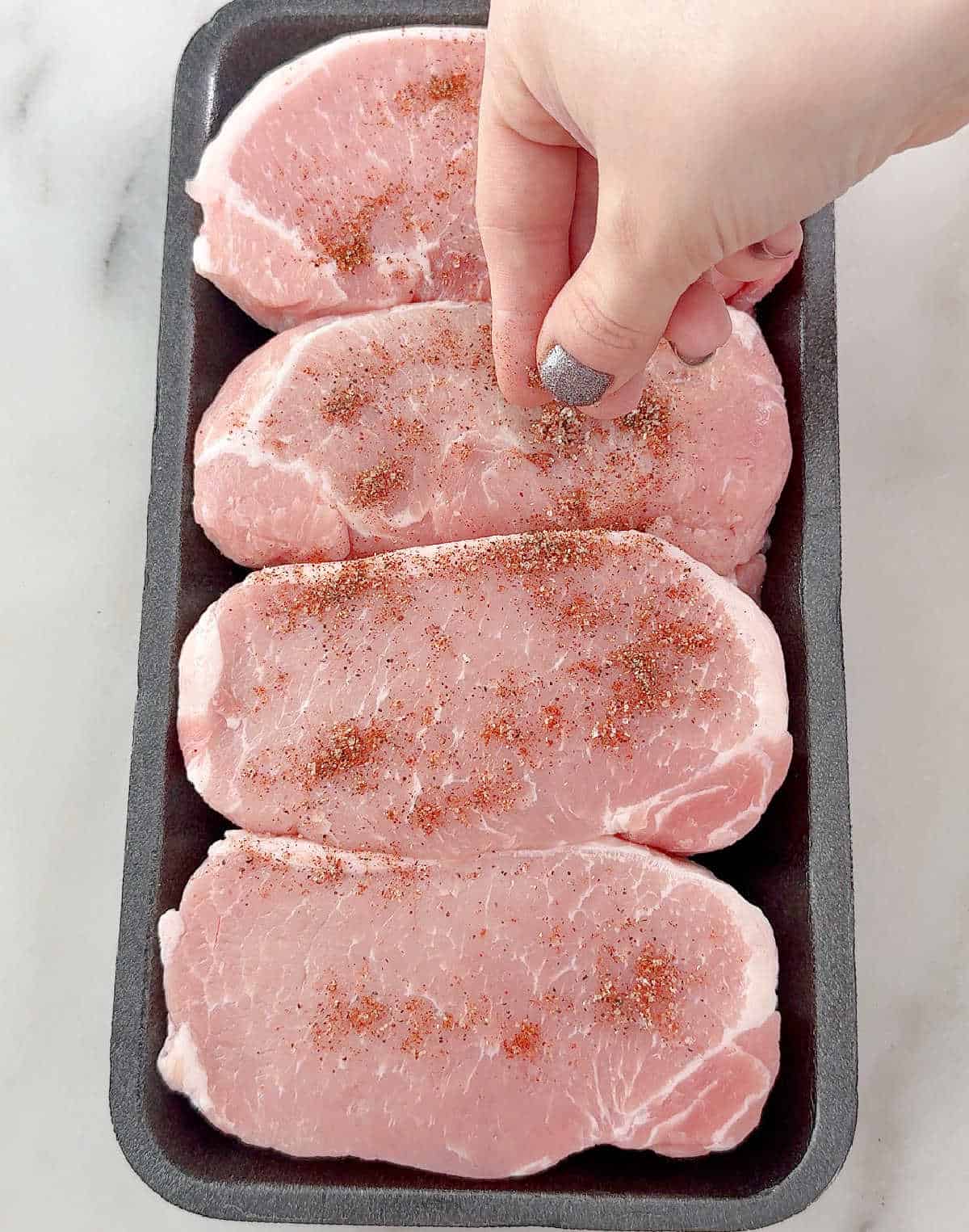 seasoning pork chops.