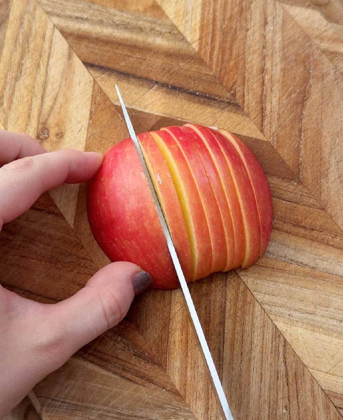 slicing honey crisp apple.
