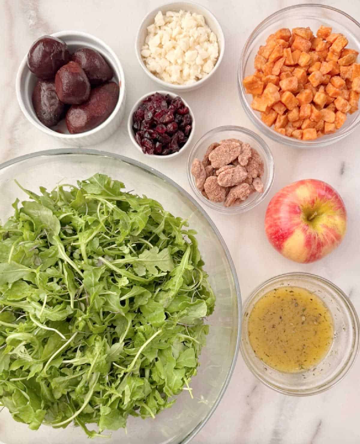 arugula, sweet potato cubes, apple, candied pecans, craisins, goat cheese, beets, dressing.