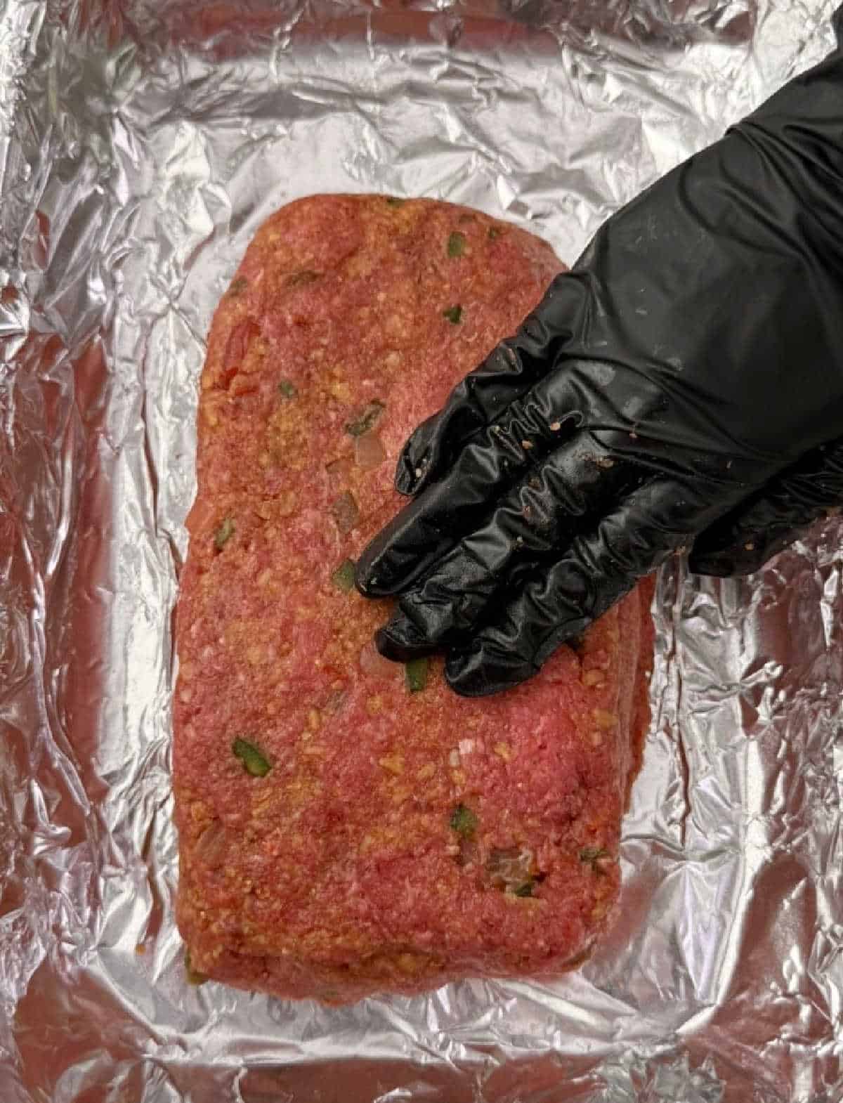 forming meat loaf in baking pan.