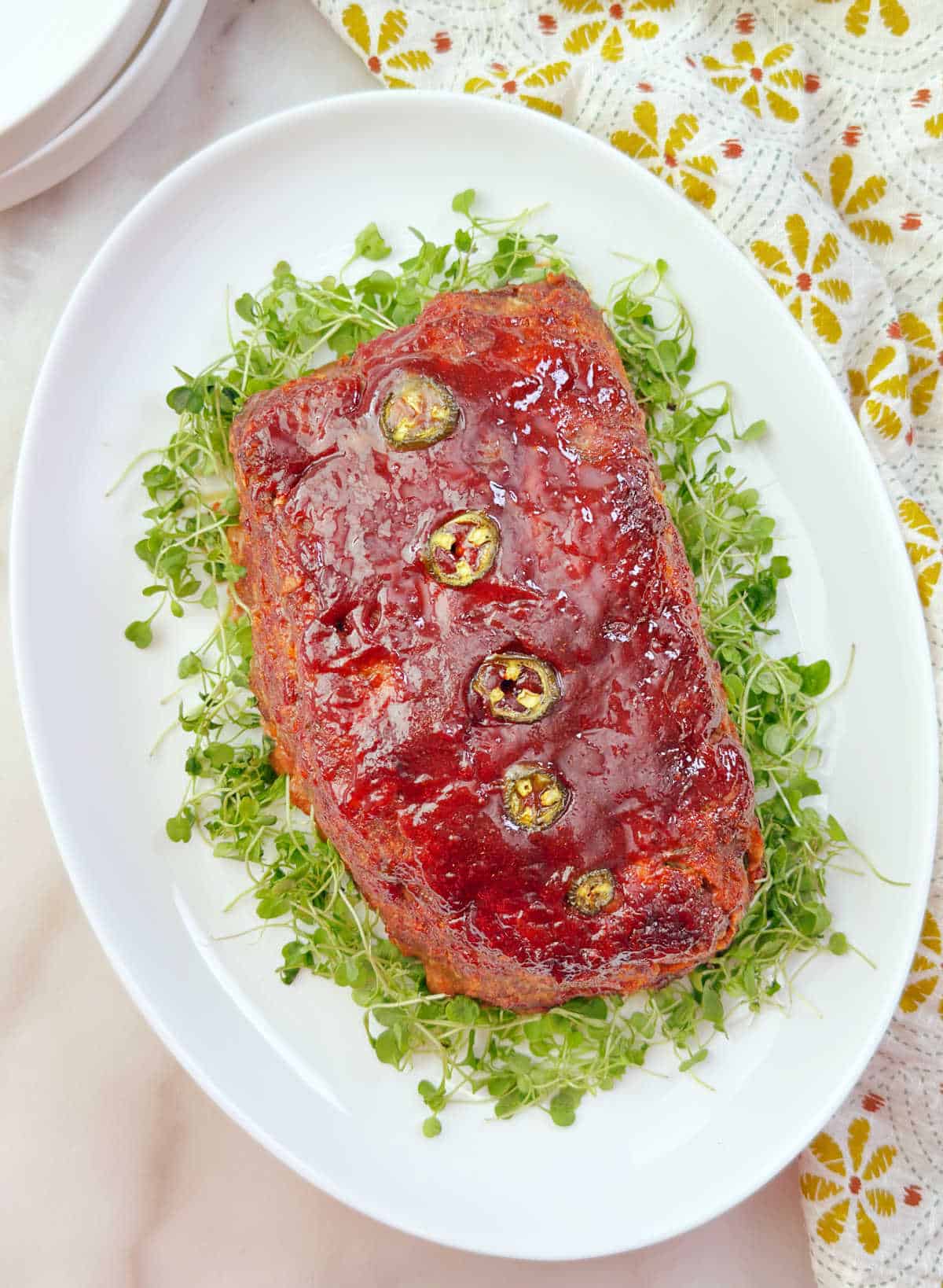 Mexican meatloaf with jalapeño slices on a platter.