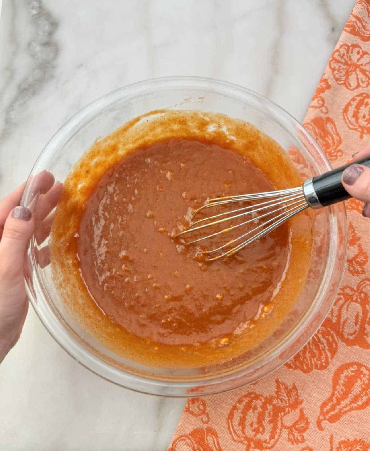 stirring wet ingredients in mixing bowl.