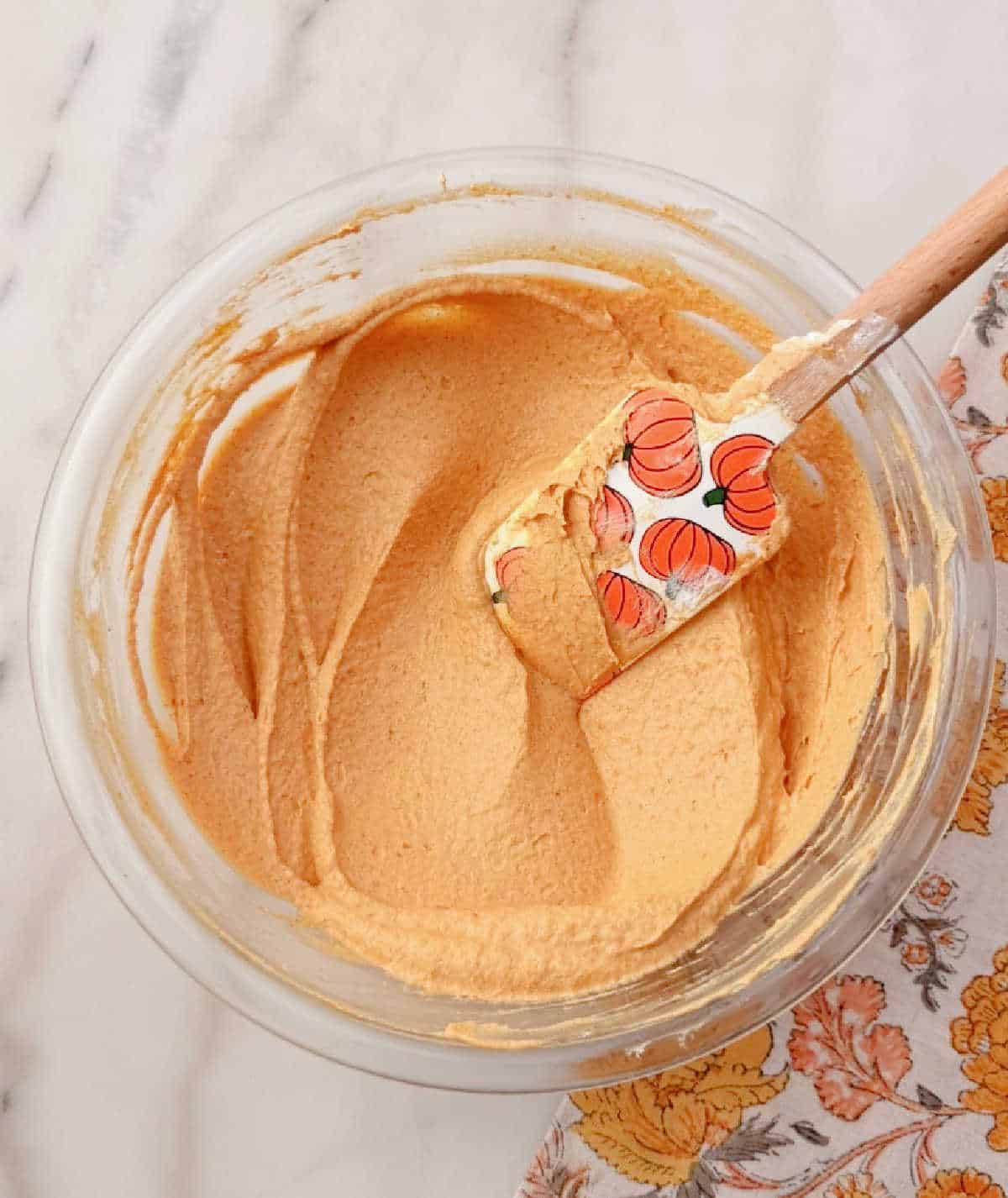 folding cool whip in with pumpkin spatula.