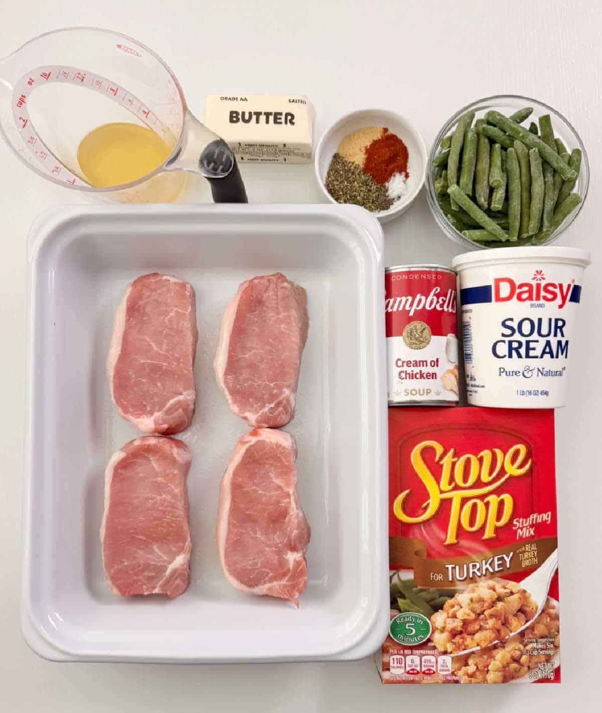 boneless pork chops, stuffing mix, sour cream, cream soup, broth, butter, seasonings and green beans.