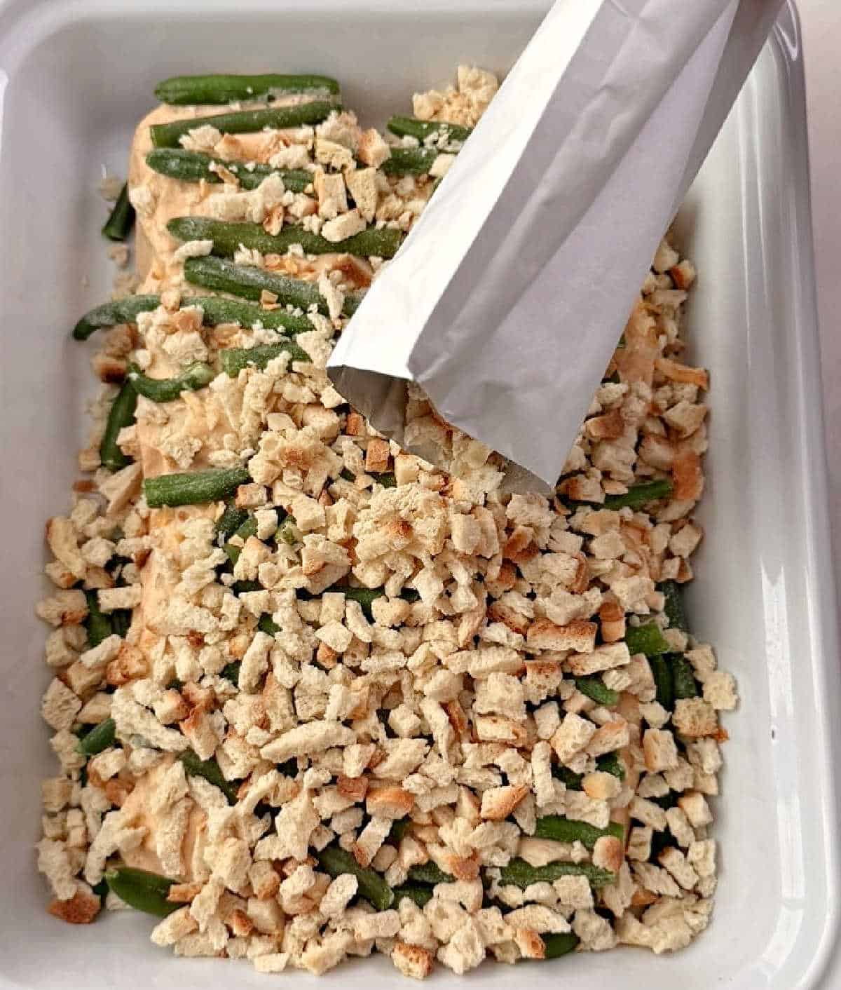 adding stuffing mix over pork chops and green beans.